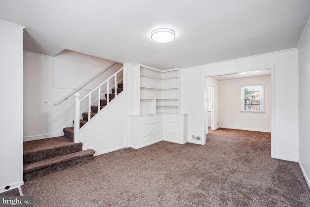 unfurnished living room featuring carpet flooring, baseboards, and stairway