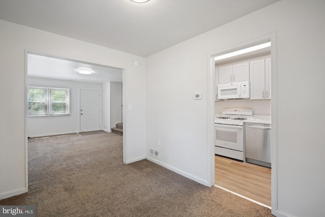 interior space featuring baseboards and light carpet