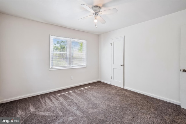 carpeted empty room with baseboards and a ceiling fan