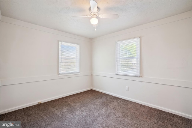 unfurnished room featuring carpet floors, a ceiling fan, a textured ceiling, and a wealth of natural light