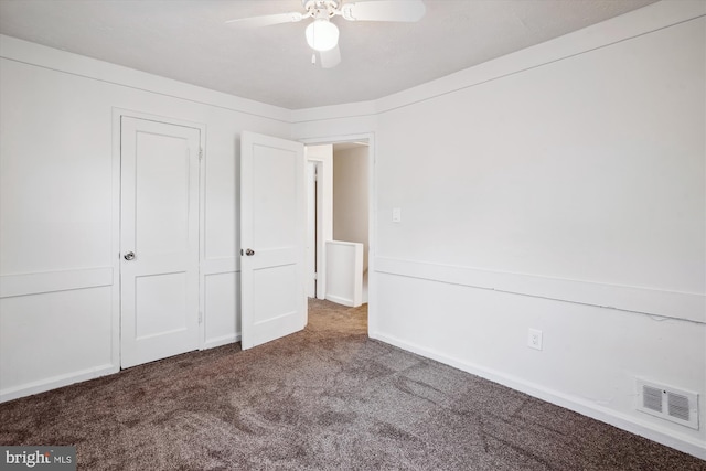 unfurnished bedroom with ceiling fan, carpet flooring, and visible vents