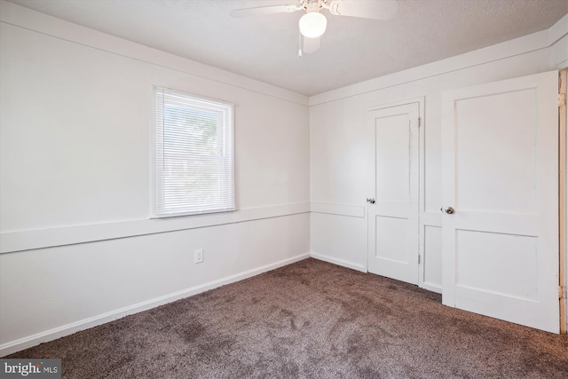 unfurnished bedroom with carpet floors, baseboards, ceiling fan, and a closet