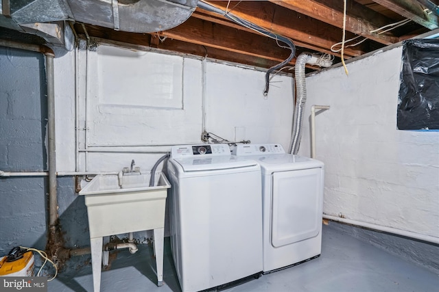 clothes washing area with separate washer and dryer and laundry area