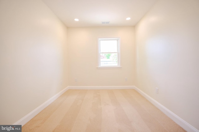 empty room with light colored carpet, baseboards, visible vents, and recessed lighting