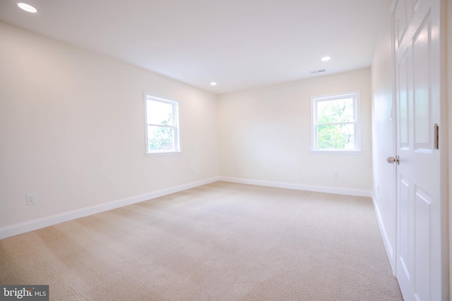 unfurnished room featuring light colored carpet, recessed lighting, and baseboards