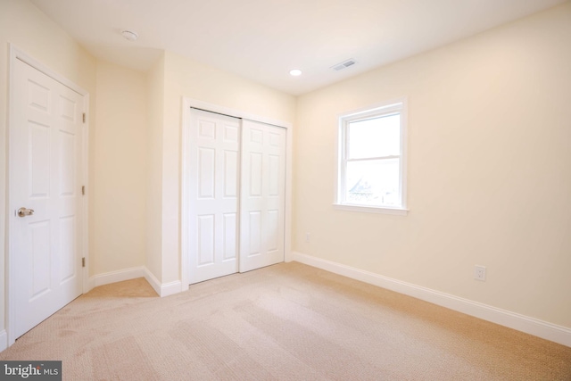 unfurnished bedroom with visible vents, baseboards, a closet, carpet flooring, and recessed lighting
