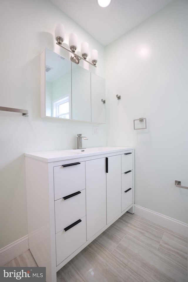 bathroom featuring baseboards and vanity