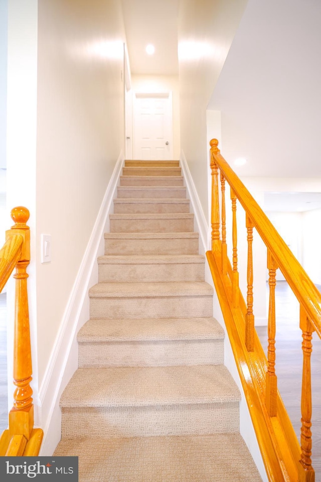 staircase with recessed lighting