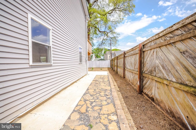 view of home's exterior with a patio and a fenced backyard