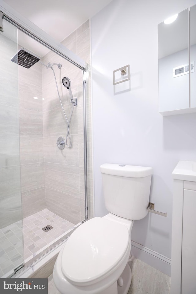full bathroom with toilet, a shower stall, wood finished floors, and vanity