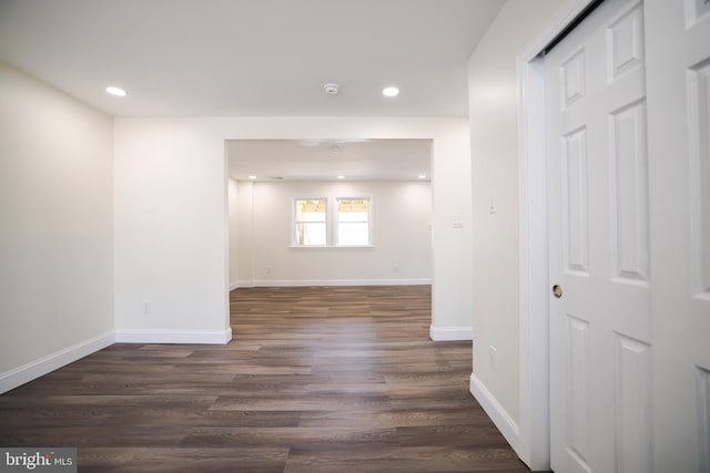 unfurnished room featuring recessed lighting, baseboards, and dark wood-type flooring