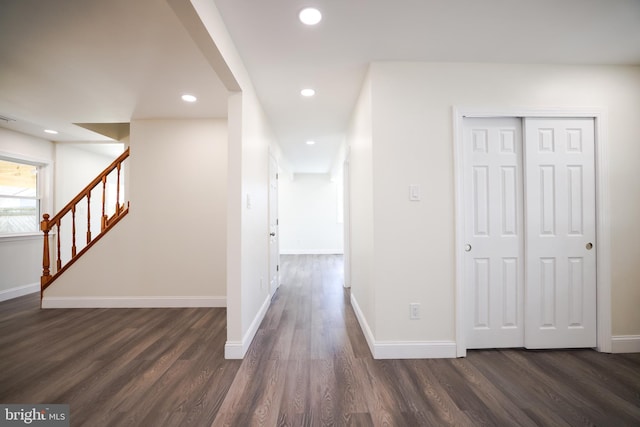 hall with recessed lighting, baseboards, dark wood finished floors, and stairway