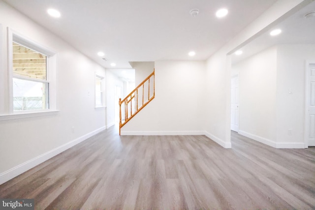interior space with stairway, baseboards, recessed lighting, and wood finished floors