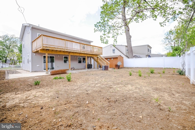 back of property with stairs, a fenced backyard, a patio area, and a wooden deck