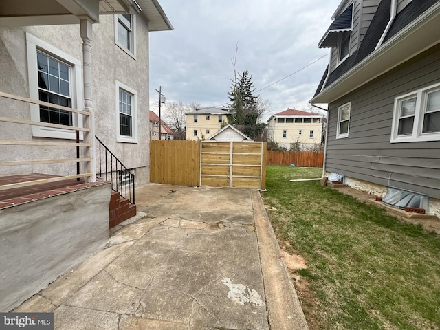 3314 Egerton Rd, Baltimore, MD 21215 - view of side of home featuring a lawn, fence, and a patio