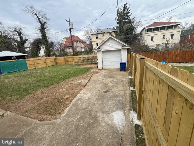 3314 Egerton Rd, Baltimore, MD 21215 - view of yard featuring a detached garage, an outdoor structure, concrete driveway, and a fenced backyard