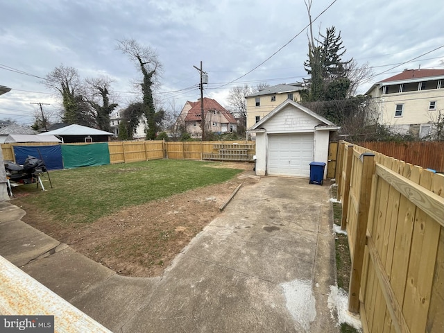 3314 Egerton Rd, Baltimore, MD 21215 - view of yard with a detached garage, driveway, an outdoor structure, and a fenced backyard