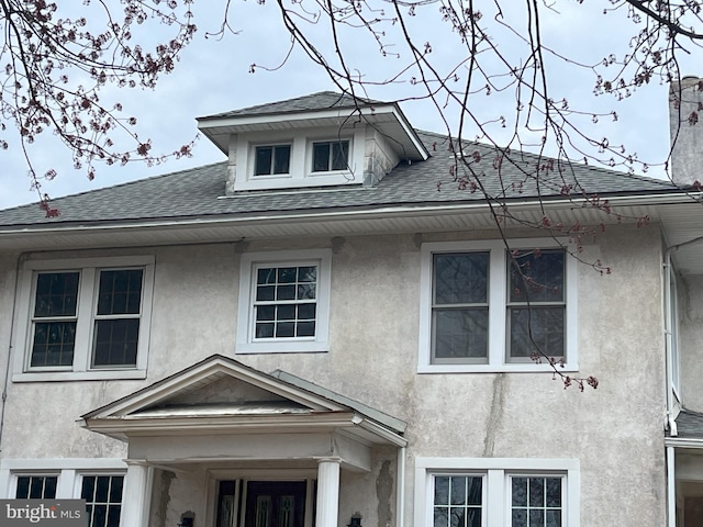 3314 Egerton Rd, Baltimore, MD 21215 - view of front facade featuring roof with shingles and stucco siding