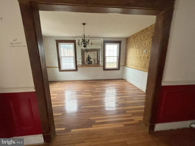 3314 Egerton Rd, Baltimore, MD 21215 - unfurnished dining area featuring an inviting chandelier, baseboards, and wood finished floors
