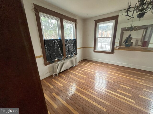 3314 Egerton Rd, Baltimore, MD 21215 - empty room with baseboards, radiator, and hardwood / wood-style floors