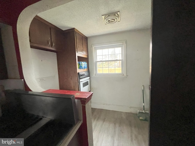3314 Egerton Rd, Baltimore, MD 21215 - kitchen with baseboards, a textured ceiling, wood finished floors, and oven