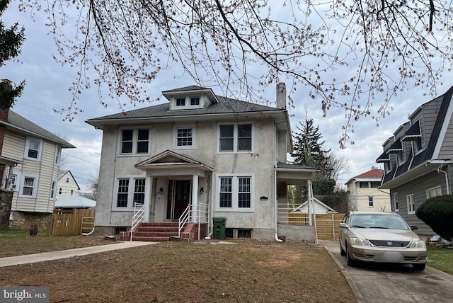 3314 Egerton Rd, Baltimore, MD 21215 - traditional style home featuring fence, stucco siding, and a chimney
