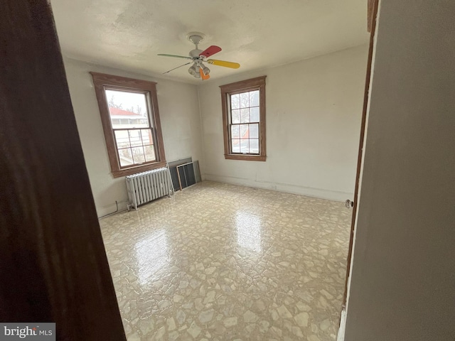 3314 Egerton Rd, Baltimore, MD 21215 - empty room with ceiling fan and radiator heating unit