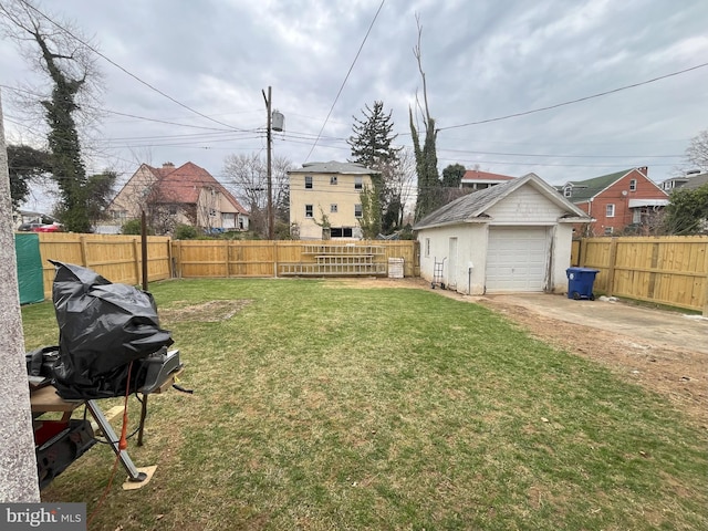 3314 Egerton Rd, Baltimore, MD 21215 - view of yard featuring an outdoor structure, a fenced backyard, driveway, and a detached garage