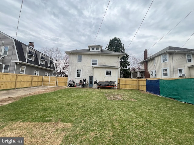 3314 Egerton Rd, Baltimore, MD 21215 - rear view of property featuring stucco siding, fence, a yard, and cooling unit