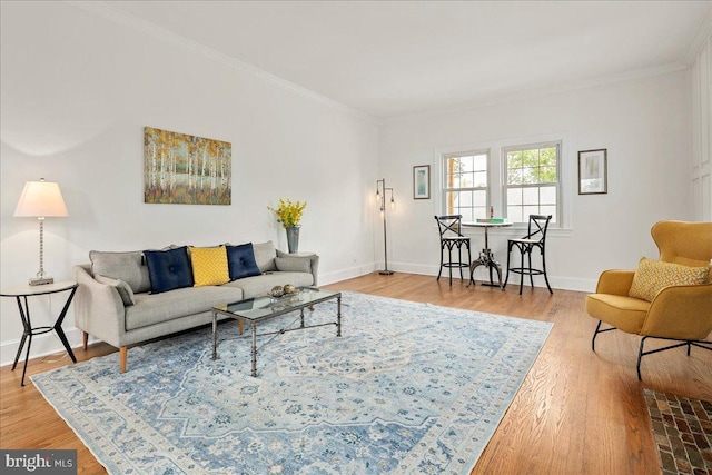 living area with baseboards and ornamental molding