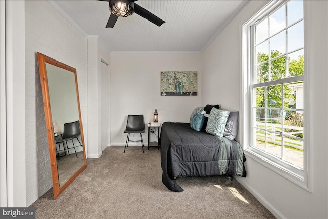 living area with carpet floors, ornamental molding, baseboards, and ceiling fan