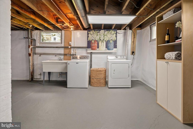 unfinished basement with a sink and washer and dryer