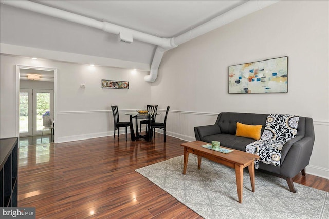living area with french doors, baseboards, and wood finished floors
