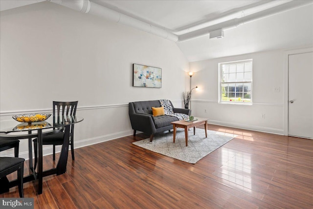 living room with wood finished floors, baseboards, and lofted ceiling