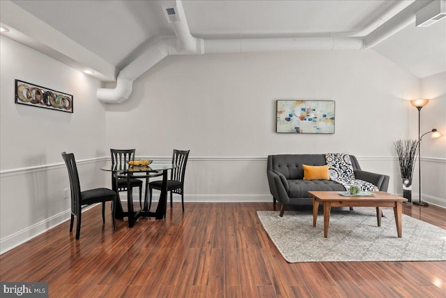 dining space with baseboards, dark wood-style flooring, lofted ceiling, and visible vents