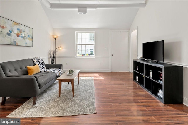 living room featuring baseboards, vaulted ceiling, wood finished floors, and visible vents