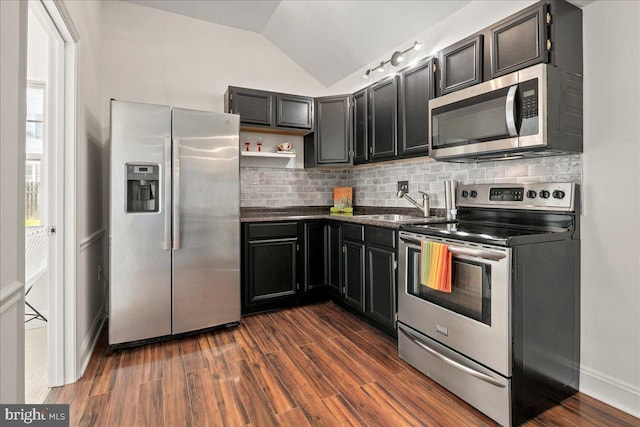 kitchen with open shelves, dark countertops, tasteful backsplash, a sink, and stainless steel appliances