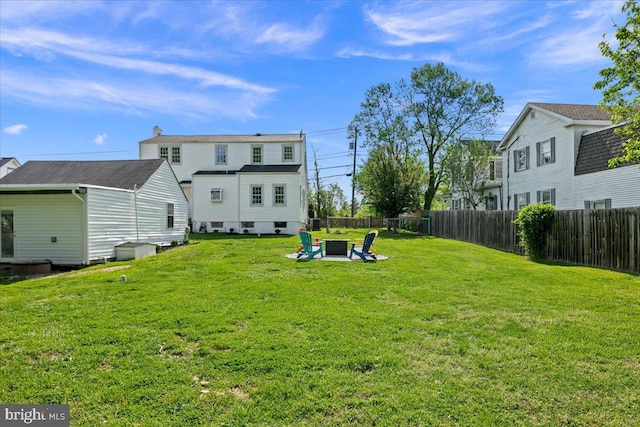 view of yard featuring fence and a fire pit