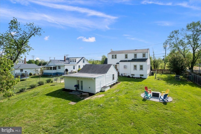 rear view of property with a yard, a fenced backyard, and a patio area