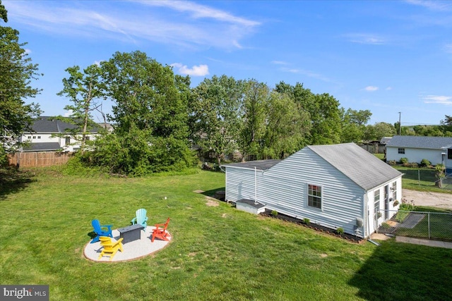view of yard featuring fence and a fire pit