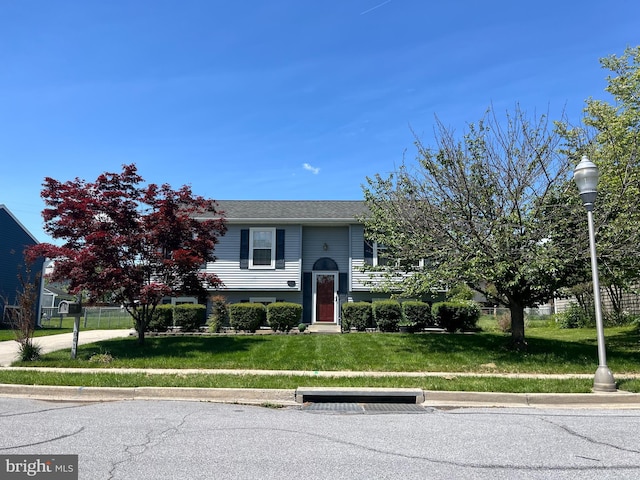raised ranch with a front yard