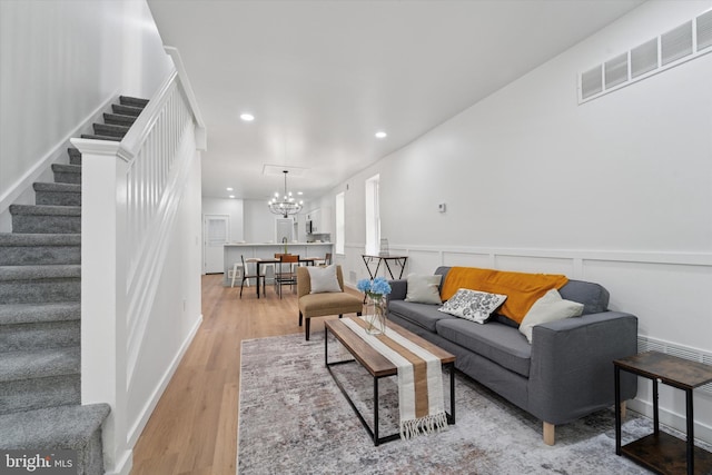 25 N Brown St, Gloucester City, NJ 08030 - living area with stairway, a chandelier, wood finished floors, recessed lighting, and wainscoting