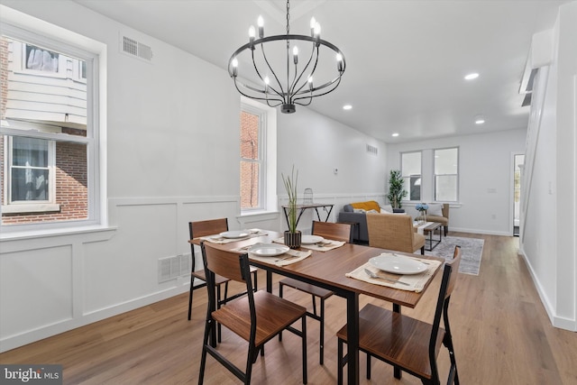 25 N Brown St, Gloucester City, NJ 08030 - dining space with light wood-style flooring, a decorative wall, wainscoting, a chandelier, and recessed lighting