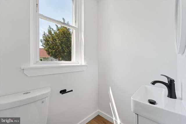 25 N Brown St, Gloucester City, NJ 08030 - half bath with plenty of natural light, a sink, toilet, and baseboards