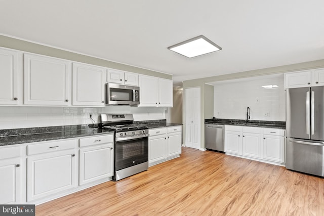 1263 Wilshire Dr, Herndon, VA 20170 - kitchen with appliances with stainless steel finishes, white cabinets, light wood-type flooring, and tasteful backsplash