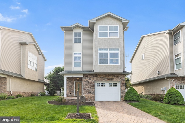 view of front of house featuring stone siding, an attached garage, a front yard, and decorative driveway