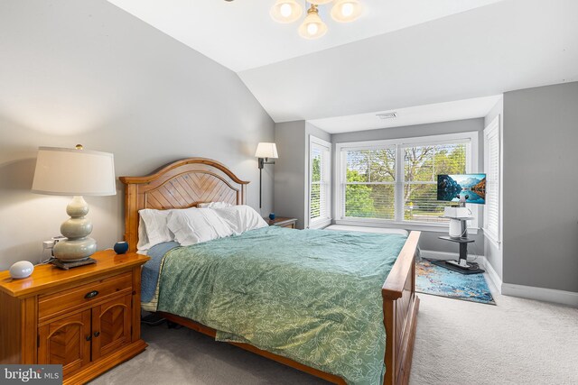 bedroom with light carpet, baseboards, and lofted ceiling