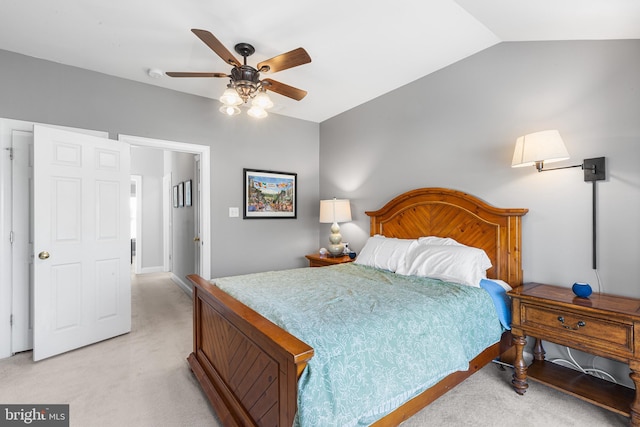 bedroom with vaulted ceiling, light carpet, and ceiling fan