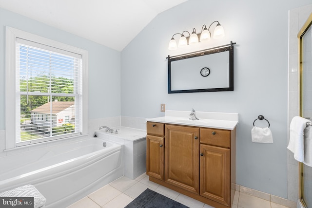 full bathroom featuring lofted ceiling, tile patterned floors, a garden tub, and vanity
