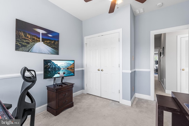 carpeted home office featuring ceiling fan and baseboards